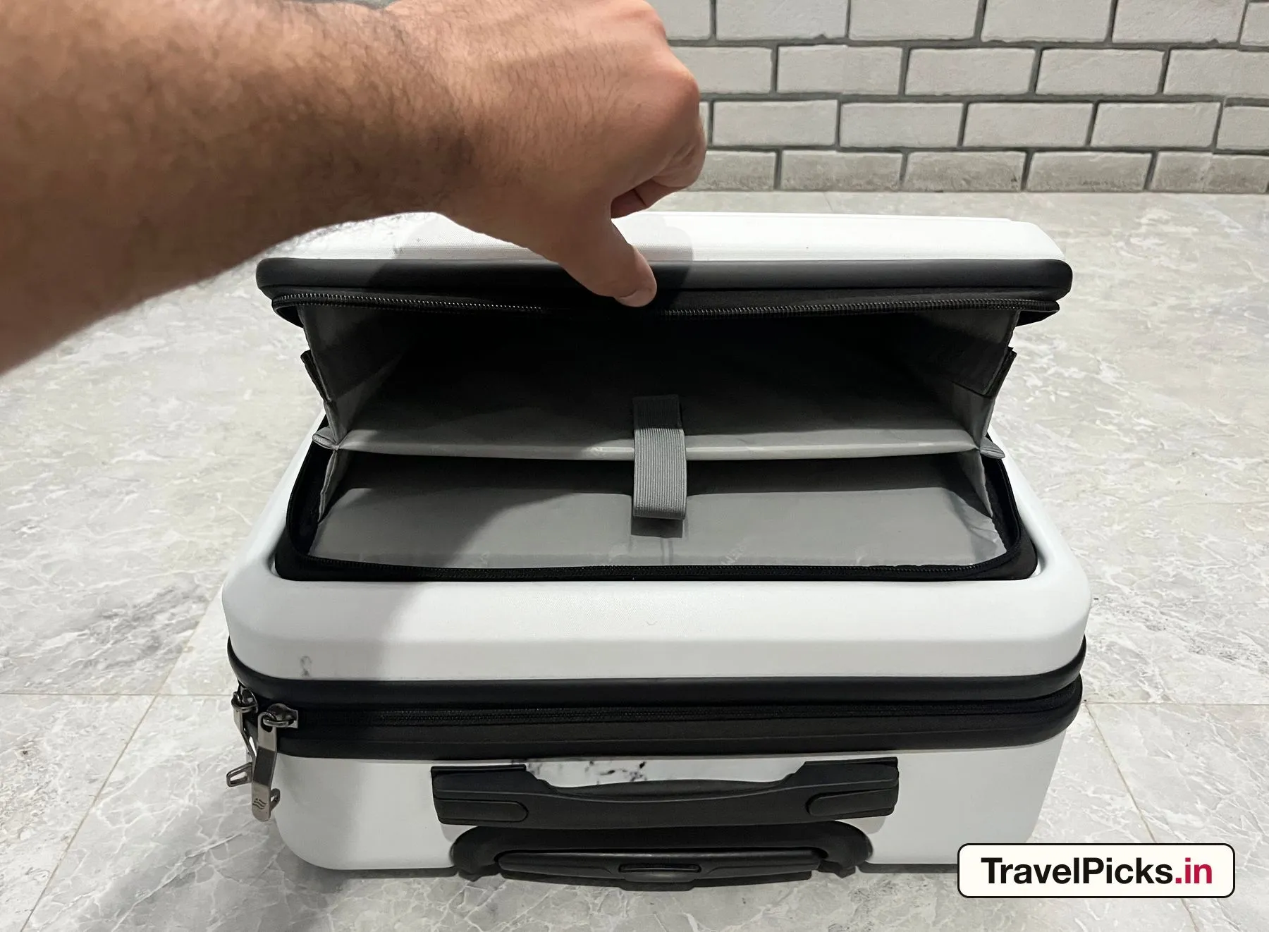 The front compartment held open, showing the padded inner sleeve and the accessory pocket above it.