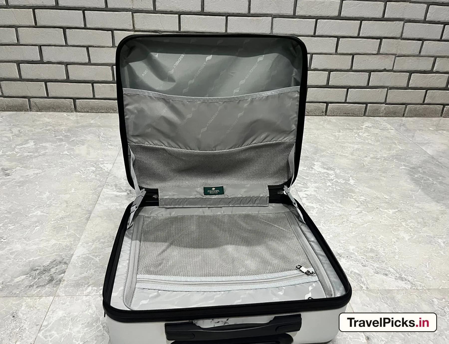 The main case opened flat with the divider curtain lifted, showing the mesh pockets on both halves.