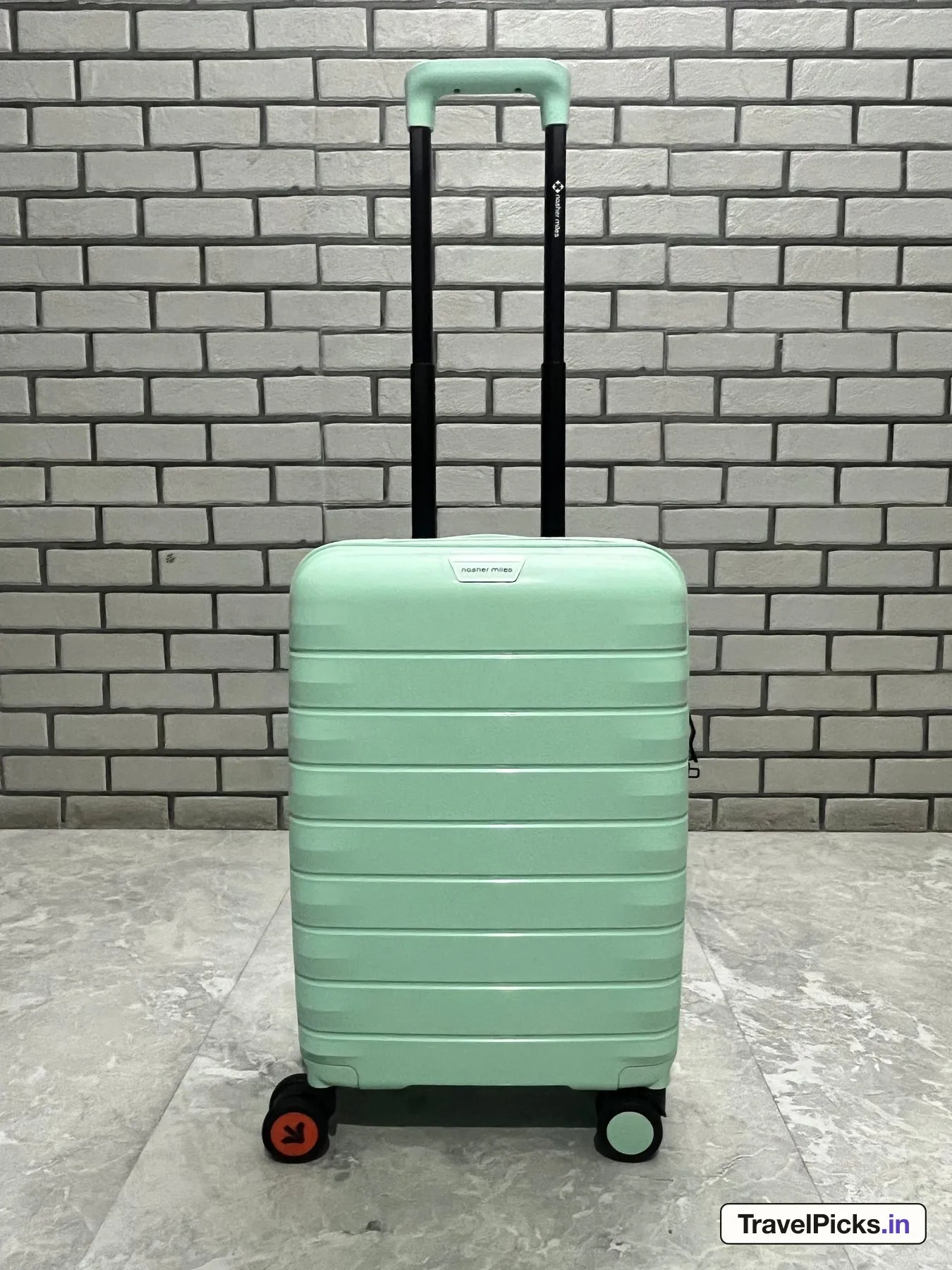 The case from the front with its black telescopic handle drawn up to full height, the brand printed on one tube.